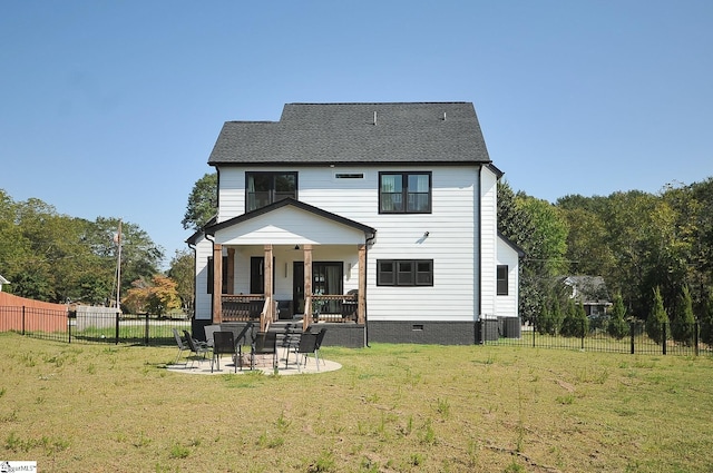 back of property with roof with shingles, a lawn, crawl space, a patio area, and fence