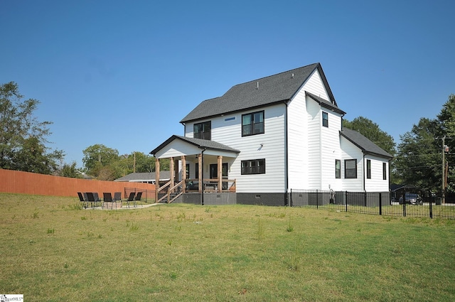 back of house with crawl space, a yard, and fence