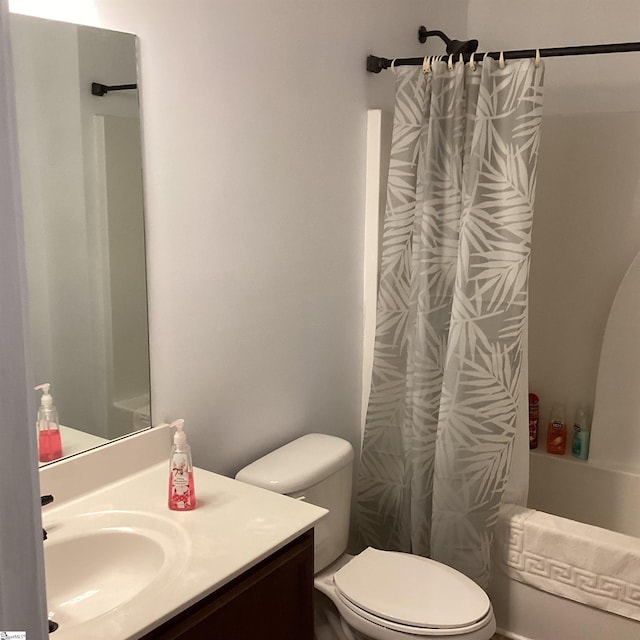 bathroom featuring shower / bath combination with curtain, vanity, and toilet