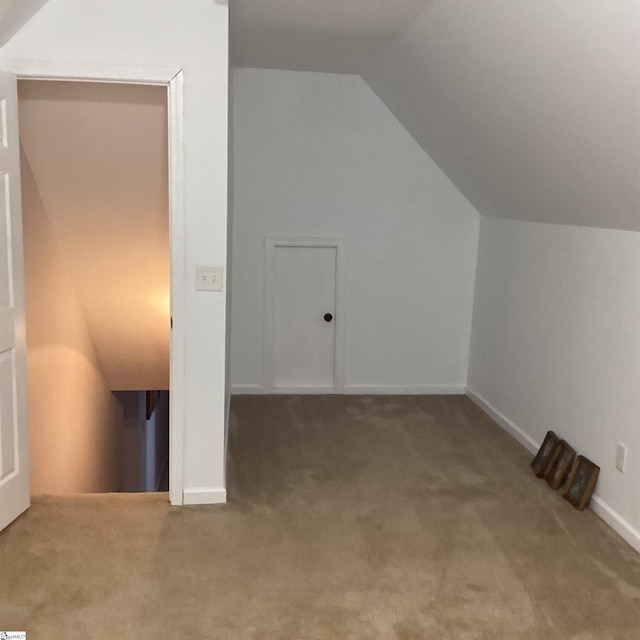 bonus room featuring vaulted ceiling, carpet floors, and baseboards