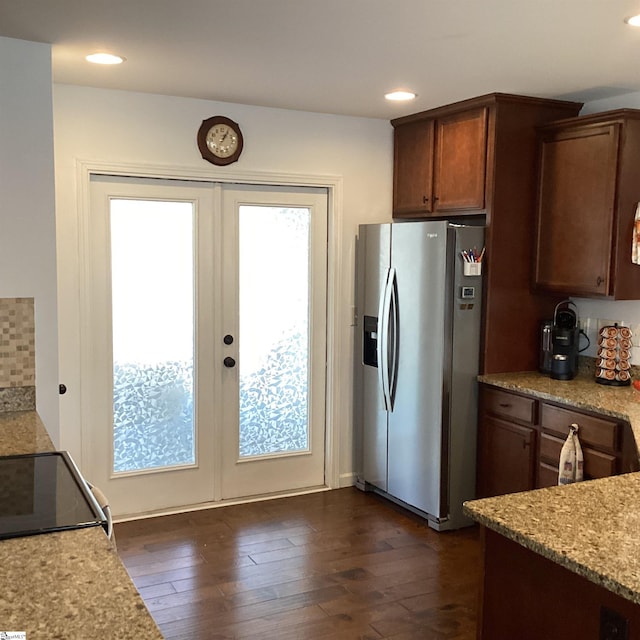 kitchen featuring stainless steel fridge, dark wood-style flooring, light stone countertops, french doors, and recessed lighting