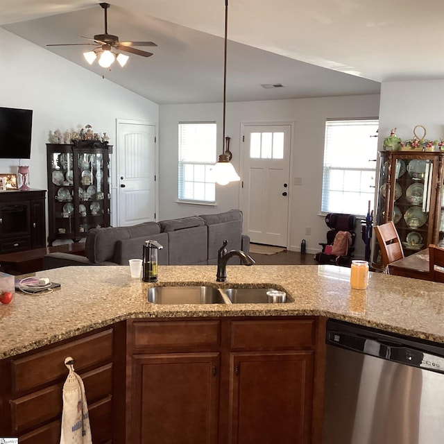 kitchen featuring open floor plan, a healthy amount of sunlight, a sink, and stainless steel dishwasher