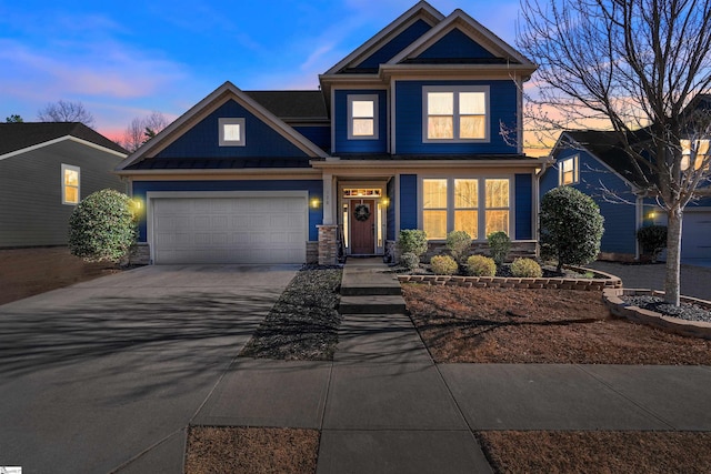 view of front of home featuring metal roof, a garage, driveway, stone siding, and a standing seam roof