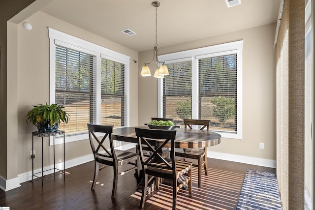 dining room featuring baseboards, visible vents, and dark wood-type flooring