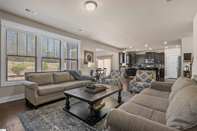 living room featuring recessed lighting, visible vents, dark wood finished floors, and baseboards