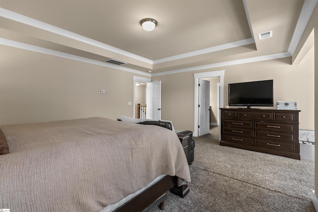 carpeted bedroom featuring crown molding, visible vents, and a tray ceiling