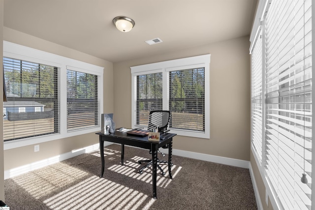 office area featuring dark colored carpet, visible vents, and baseboards