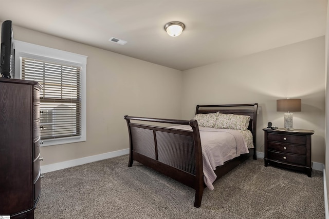 carpeted bedroom featuring visible vents and baseboards