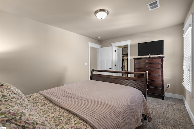 carpeted bedroom with visible vents and baseboards