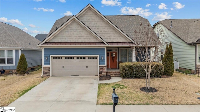 craftsman-style home with metal roof, a garage, driveway, stone siding, and a standing seam roof