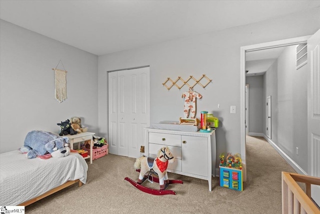 carpeted bedroom with a closet and visible vents