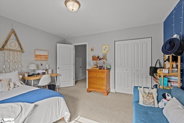 bedroom with a closet and light colored carpet