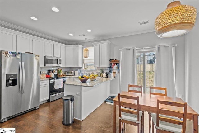 kitchen featuring a wealth of natural light, visible vents, appliances with stainless steel finishes, and crown molding