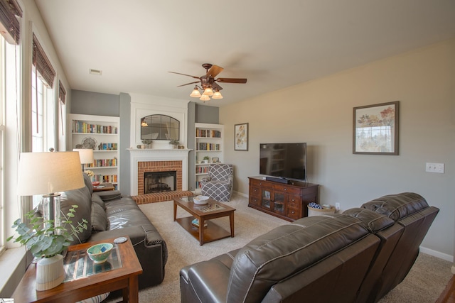 living room with ceiling fan, a fireplace, carpet flooring, and baseboards