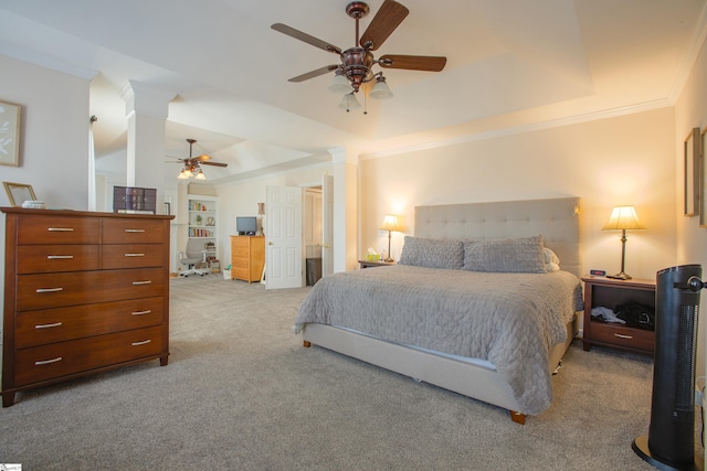 carpeted bedroom featuring ceiling fan, ornamental molding, a raised ceiling, and ornate columns