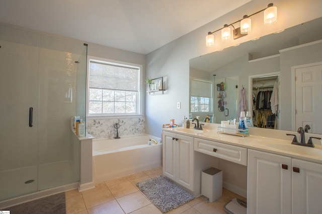 bathroom with a sink, a shower stall, a bath, and tile patterned floors