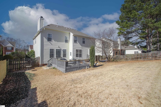 back of house featuring crawl space, a chimney, a fenced backyard, and a lawn