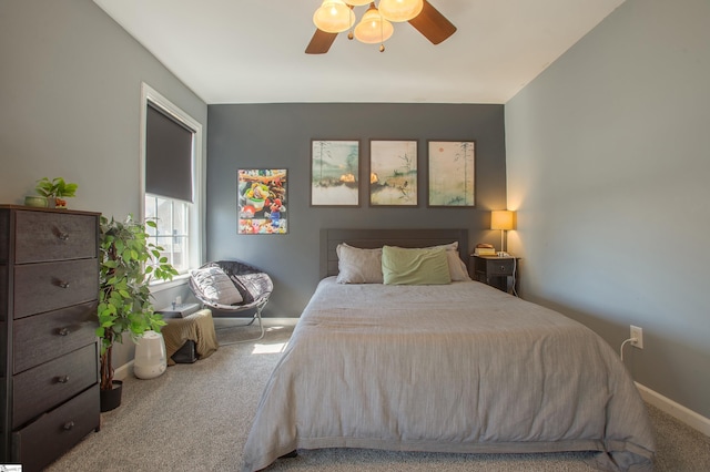 carpeted bedroom featuring a ceiling fan and baseboards