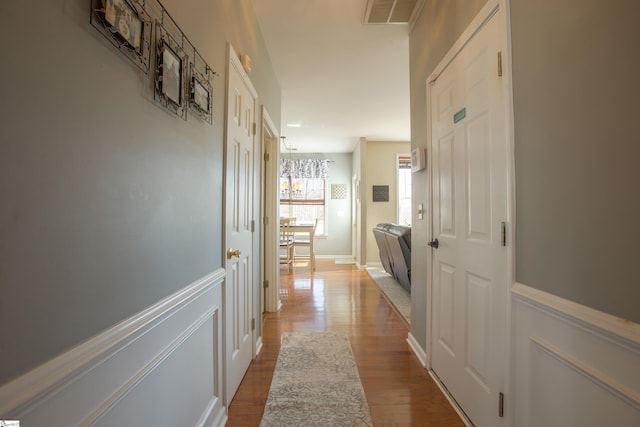 corridor featuring dark wood finished floors and visible vents