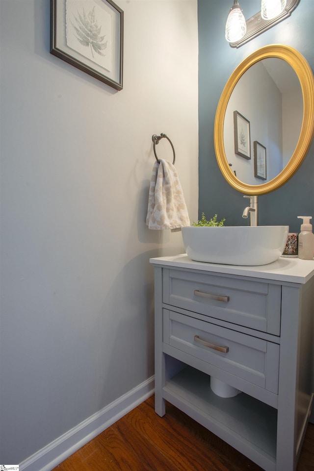 bathroom featuring vanity, baseboards, and wood finished floors