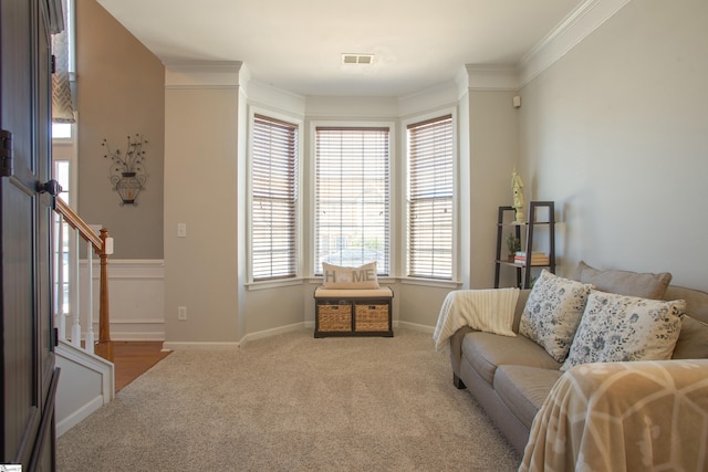 interior space with baseboards, visible vents, stairway, ornamental molding, and carpet floors