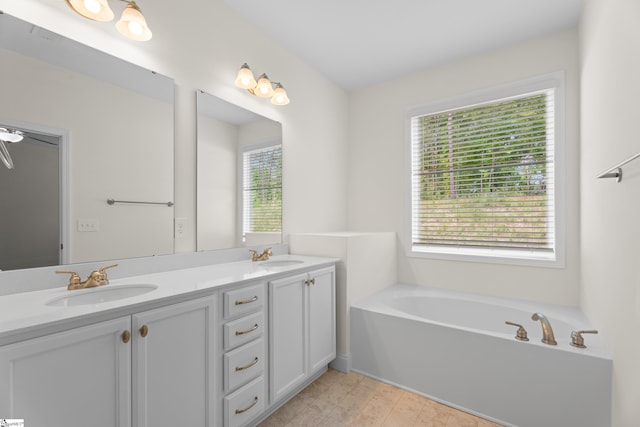 full bath featuring double vanity, a garden tub, and a sink