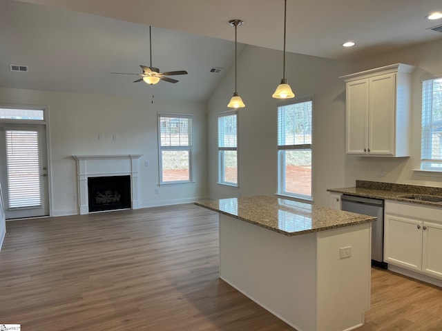 kitchen featuring a center island, white cabinets, visible vents, and dishwasher