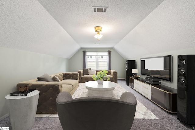 living room with vaulted ceiling, a textured ceiling, visible vents, and light colored carpet