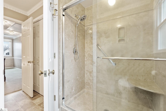 bathroom featuring a stall shower and crown molding