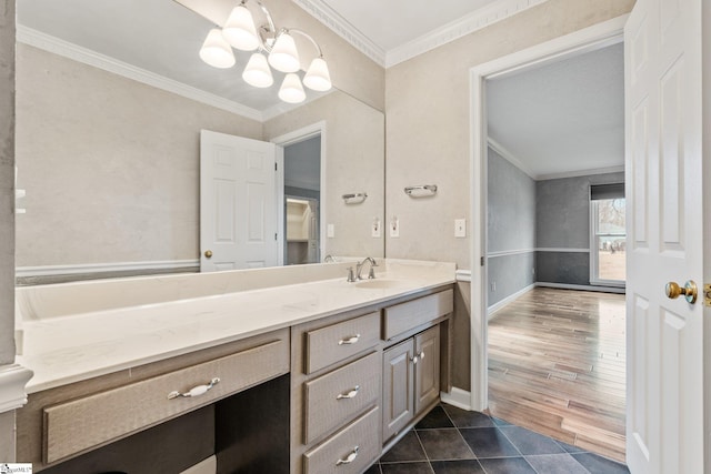 bathroom featuring baseboards, tile patterned floors, an inviting chandelier, crown molding, and vanity