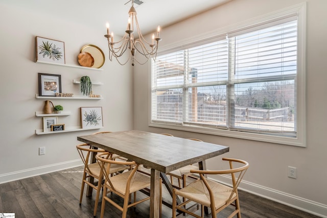 dining area with a chandelier, dark wood-style flooring, and baseboards