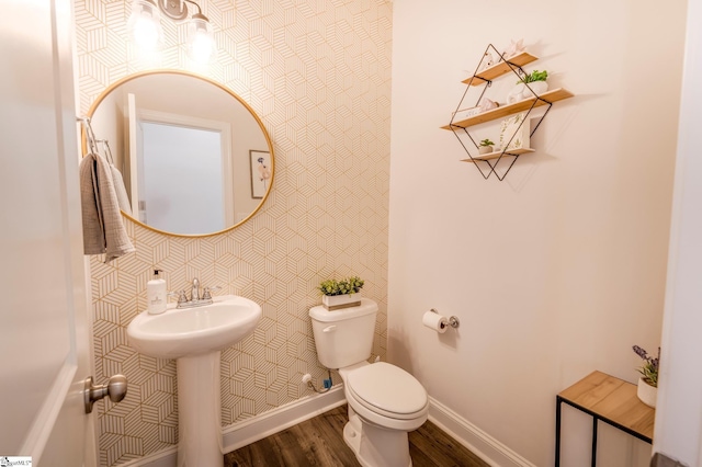 bathroom with wallpapered walls, toilet, baseboards, and wood finished floors