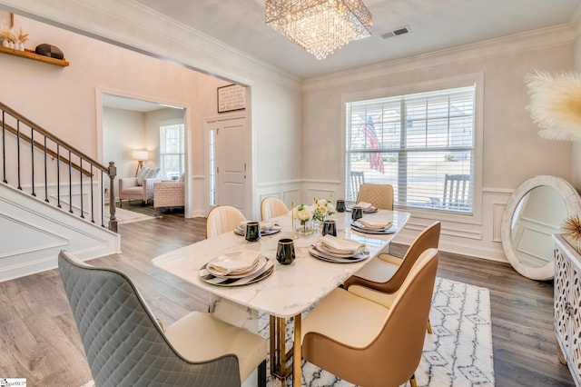 dining room with a wealth of natural light, visible vents, a notable chandelier, and stairs