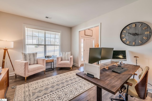 office area featuring wood finished floors, visible vents, and baseboards