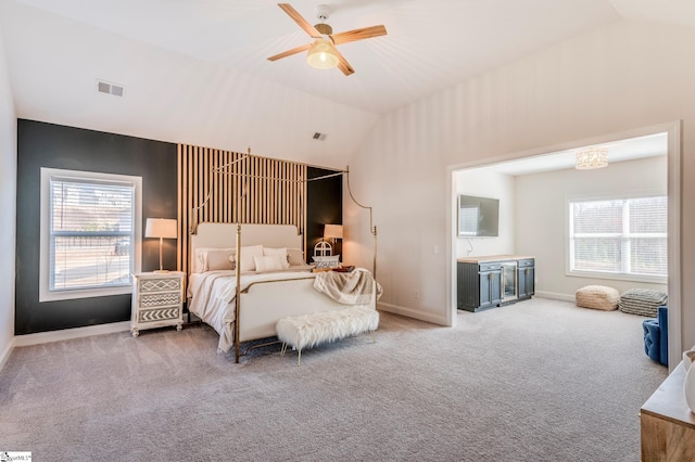 bedroom with carpet floors, multiple windows, and lofted ceiling