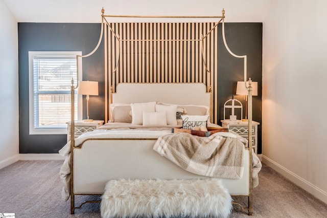 bedroom featuring carpet and baseboards