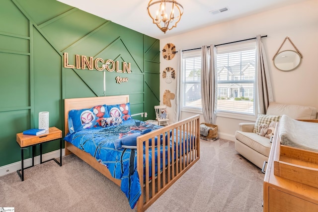 carpeted bedroom featuring baseboards, visible vents, and an inviting chandelier