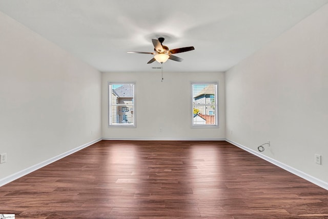 unfurnished room with a ceiling fan, dark wood-style flooring, and baseboards