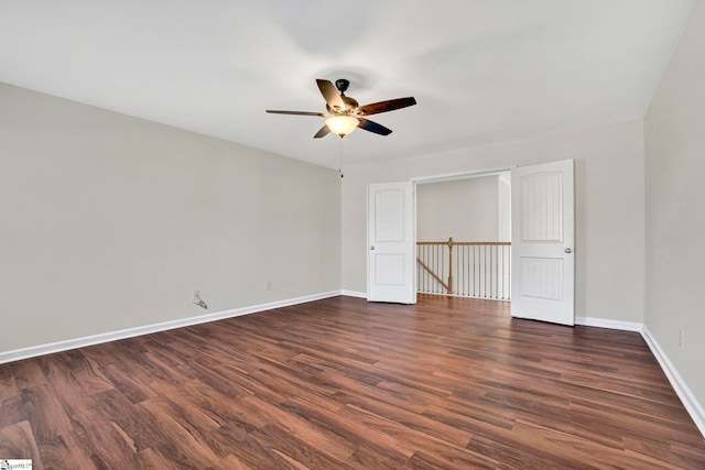 unfurnished bedroom with dark wood-style floors, ceiling fan, and baseboards