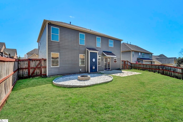 back of house with a yard, a patio, an outdoor fire pit, and a fenced backyard