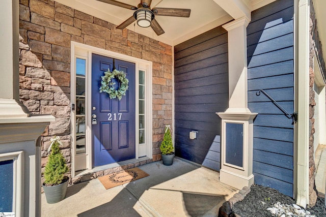 property entrance featuring ceiling fan and stone siding