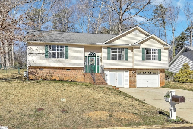 bi-level home with a garage, concrete driveway, brick siding, and a front lawn