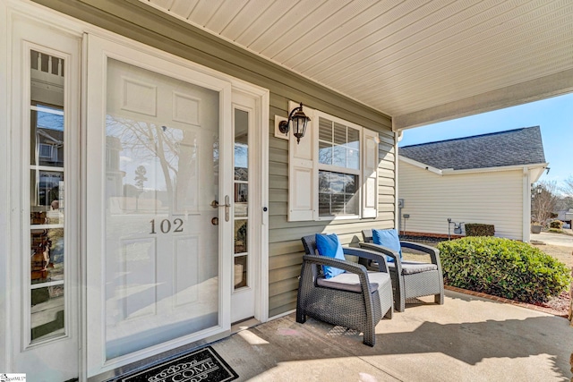 view of exterior entry with a porch