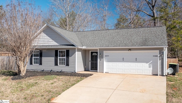 ranch-style home featuring a shingled roof, driveway, an attached garage, and fence