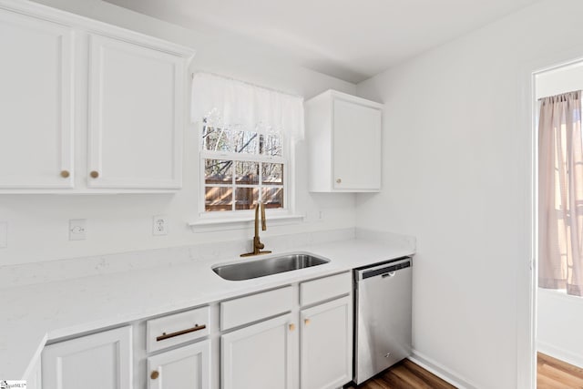 kitchen with dishwasher, dark wood-style flooring, a sink, and white cabinetry