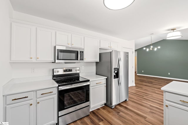 kitchen featuring white cabinets, stainless steel appliances, wood finished floors, and light countertops