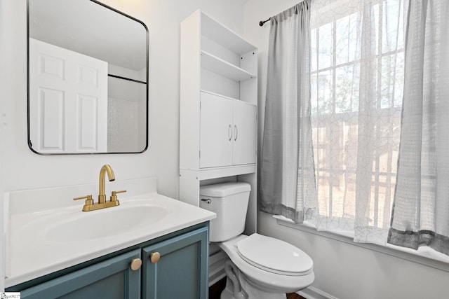 bathroom featuring toilet and vanity