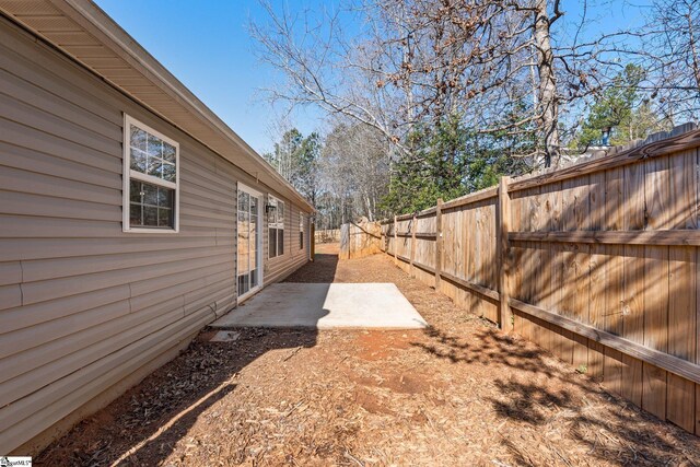 view of yard with a fenced backyard and a patio