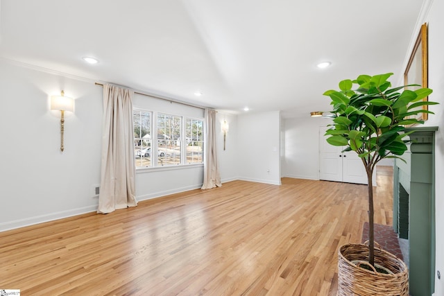 unfurnished living room featuring recessed lighting, baseboards, and wood finished floors