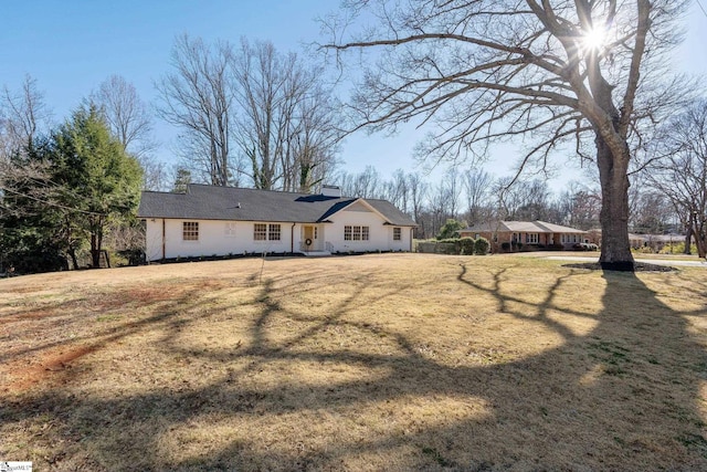 view of front of property with a chimney and a front yard